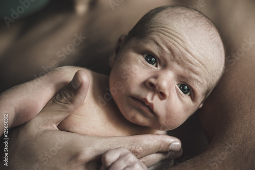 Portrait of loving father with baby at home. Sepia Toned