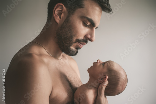 Portrait of loving father with baby at home. Sepia Toned