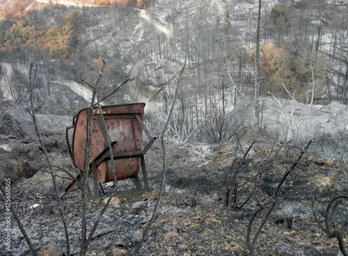 Burnt metal equipment in landscape of burnt undergrowth Greece