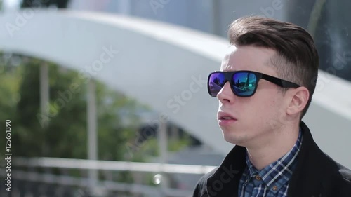 Young man smoking cigarette in the street