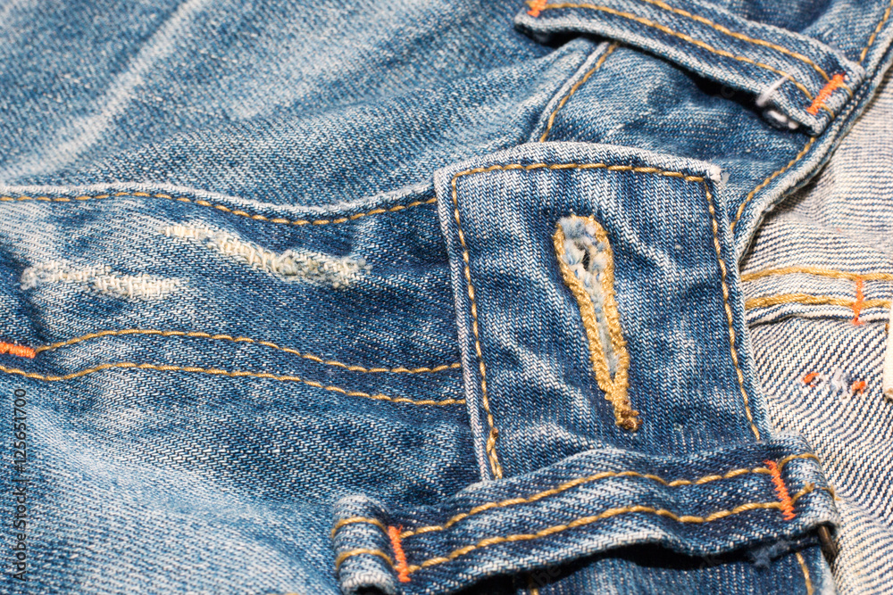 Naklejka premium old jean on wooden desk table , part of jean,