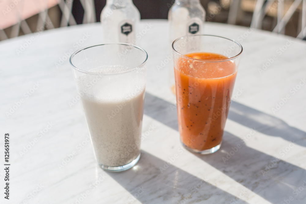 Two smoothies: vanilla and melon orange Two smoothies: vanilla and melon orange