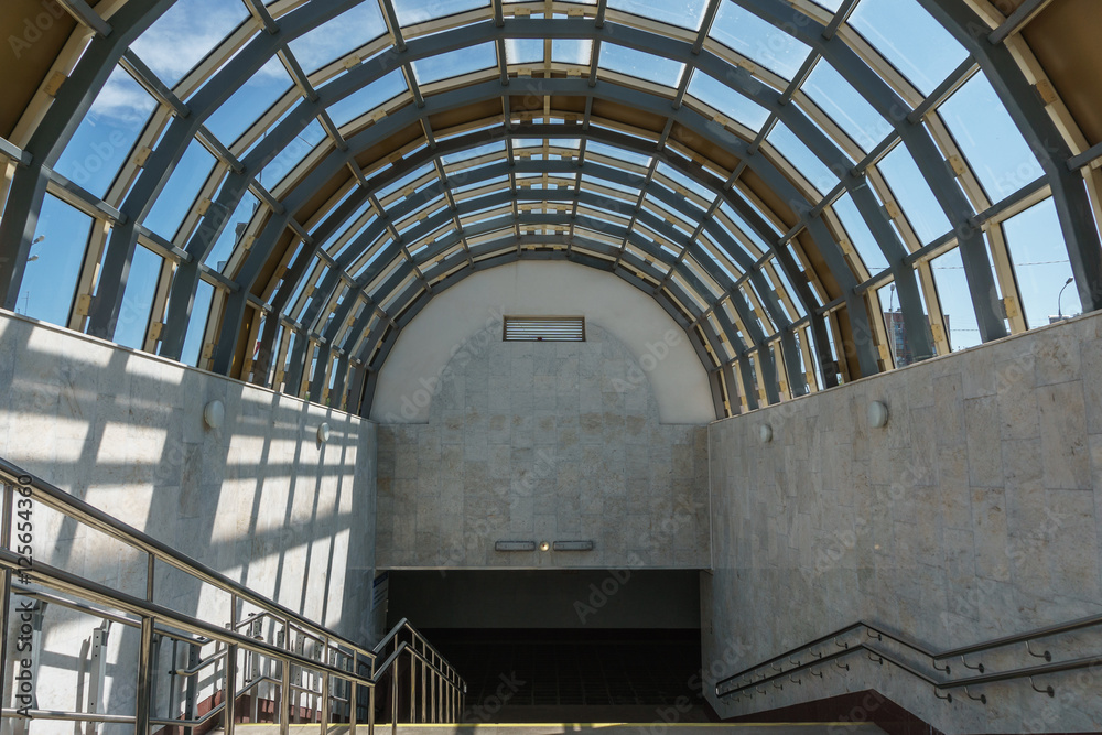 descent into the subway. A wide staircase and a glass roof in the form of  arch