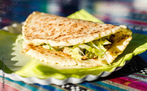 Pulled BBQ chicken sandwich made with cheese bread tortilla at a street food market