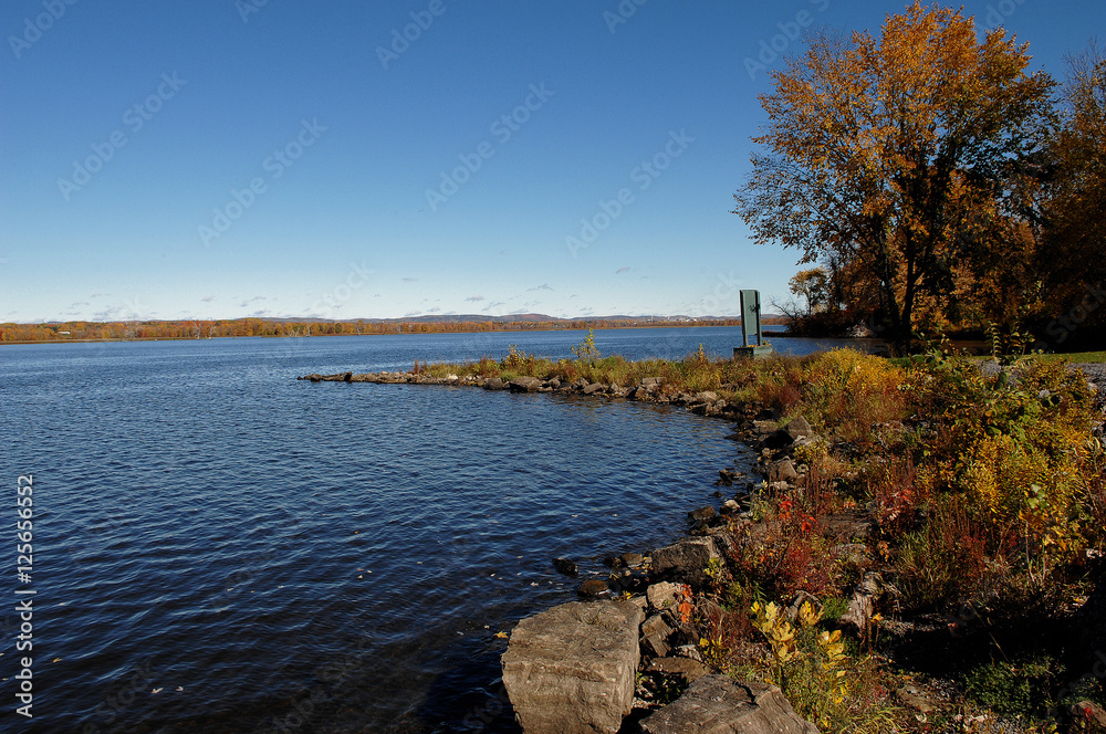 Peaceful lake under blue sky.