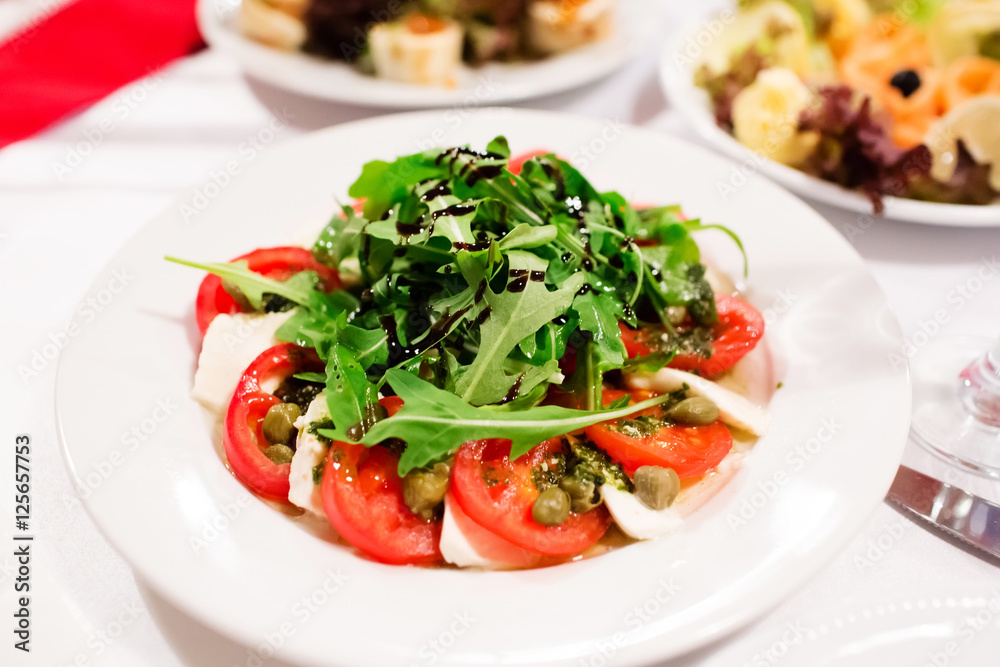 Salad with tomato, arugula and balsamic sauce Salad with tomato, arugula and balsamic sauce
