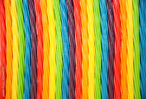 background of rainbow twisted candy. colorful twisted licorice candy, texture