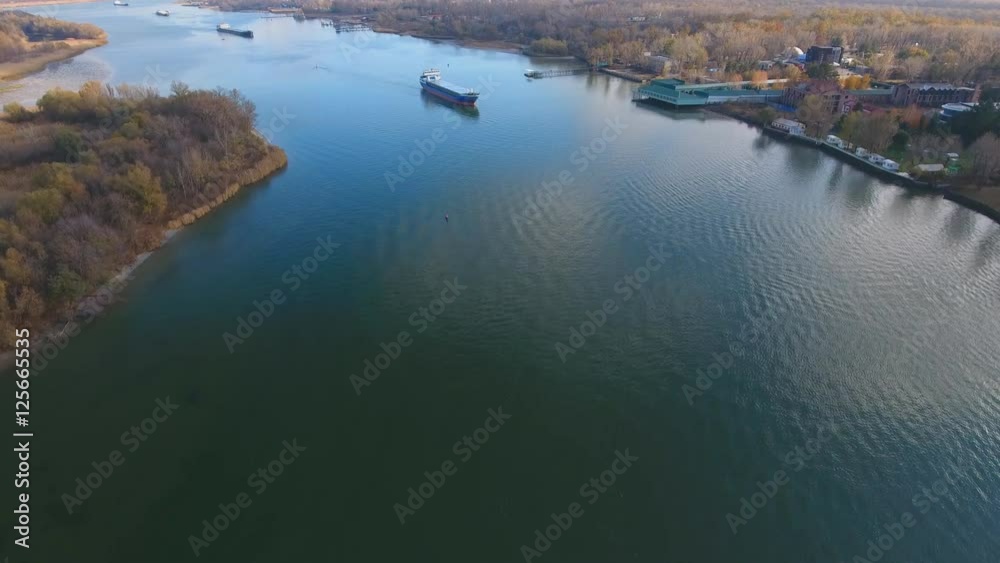Cargo ship in beautiful river. Aerial view. Autumn landscape. Cargo ship in beautiful river. Aerial view. Autumn landscape.
