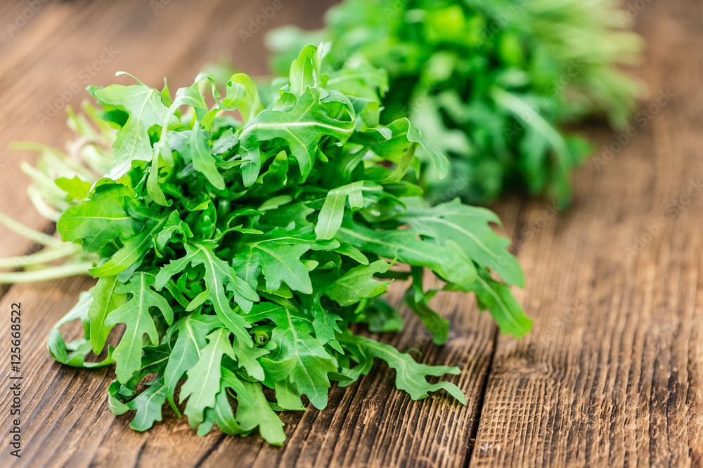 Fresh Arugula on an old wooden table Fresh Arugula on an old wooden table
