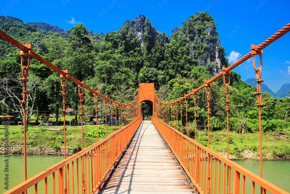 Orange bridge cross the river with mountain landscape