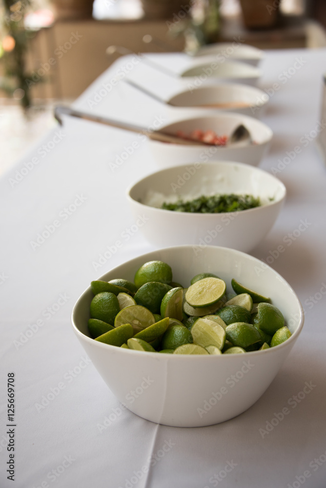 Assorted toppings for Mexican tacos on a buffet Assorted toppings for Mexican tacos on a buffet