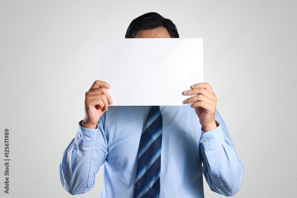 Businessman Hiding His Face Behind White Paper Businessman Hiding His Face Behind White Paper
