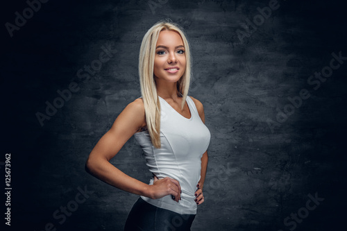 A girl in white t shirt on grey background.