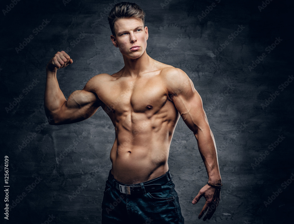 Shirtless athletic male showing biceps.