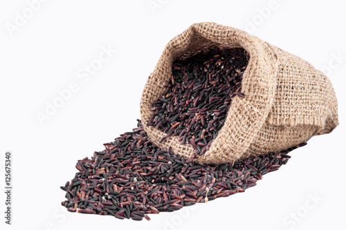 Riceberry rice in sacks on a white background © fototrips