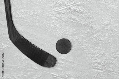 Black hockey stick and puck on the ice