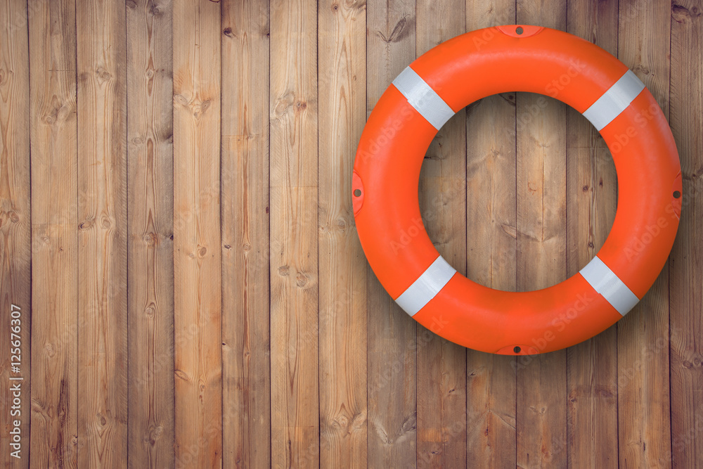 Life buoy hanging on wooden wall for emergency respone when people sinking to weter almost place neer pool and beach