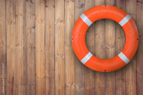 Obraz na płótnie Life buoy hanging on wooden wall for emergency respone when people sinking to weter almost place neer pool and beach w salonie