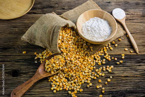 Corn flour and dried corn on a wooden table old.