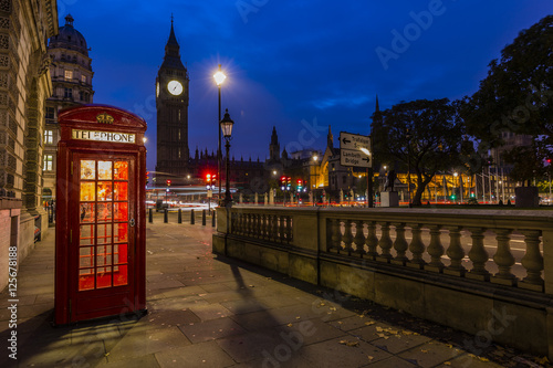 Famous English red telephone boxes with Big Ben in London at night, England, UK