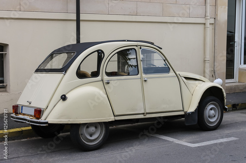 Small french retro car on a city street