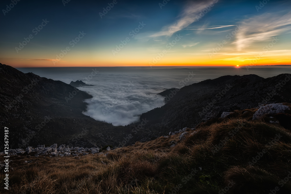 Sunset in the mountains with the sea of low clouds