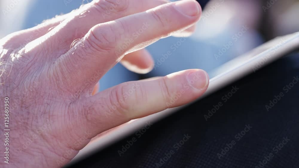 4K Close up of male hands using a tablet device, in slow motion 4K Close up of male hands using a tablet device, in slow motion