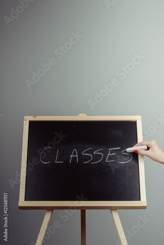 Classes written in white chalk on a black chalkboard