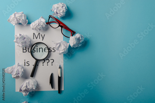 Business word with business document paper on blue background