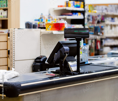Empty cash desk with terminal in supermarket