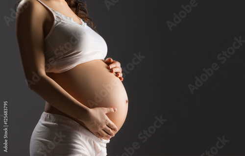 Pregnant woman caressing her belly
