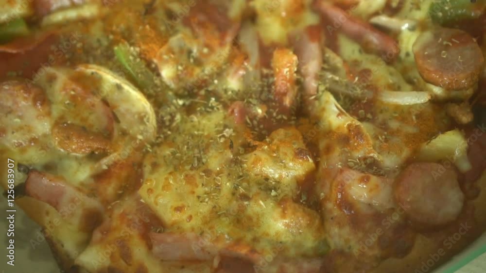 Italian pizza with meat, bacon, pepperoni and cheese closeup Italian pizza with meat, bacon, pepperoni and cheese closeup