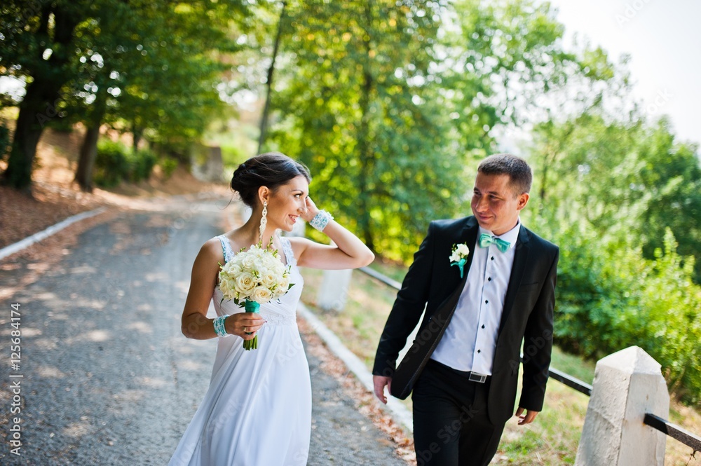 Newly wed in their wedding day at park Newly wed in their wedding day at park