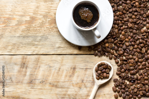 coffee beans on wooden with coffe cup table top view