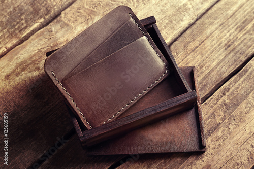 Leather wallet on wooden ba...