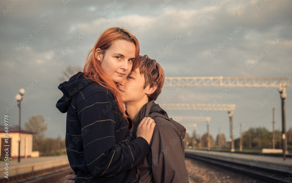 Couple on the rails, hugging