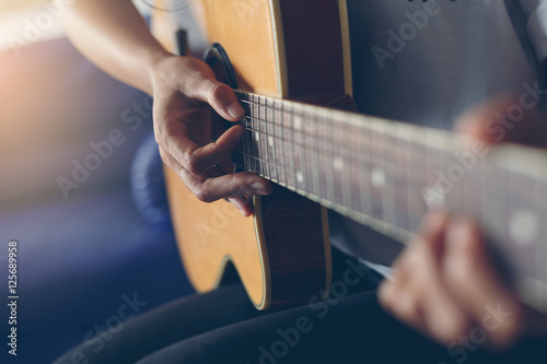woman playing guitar in her home
