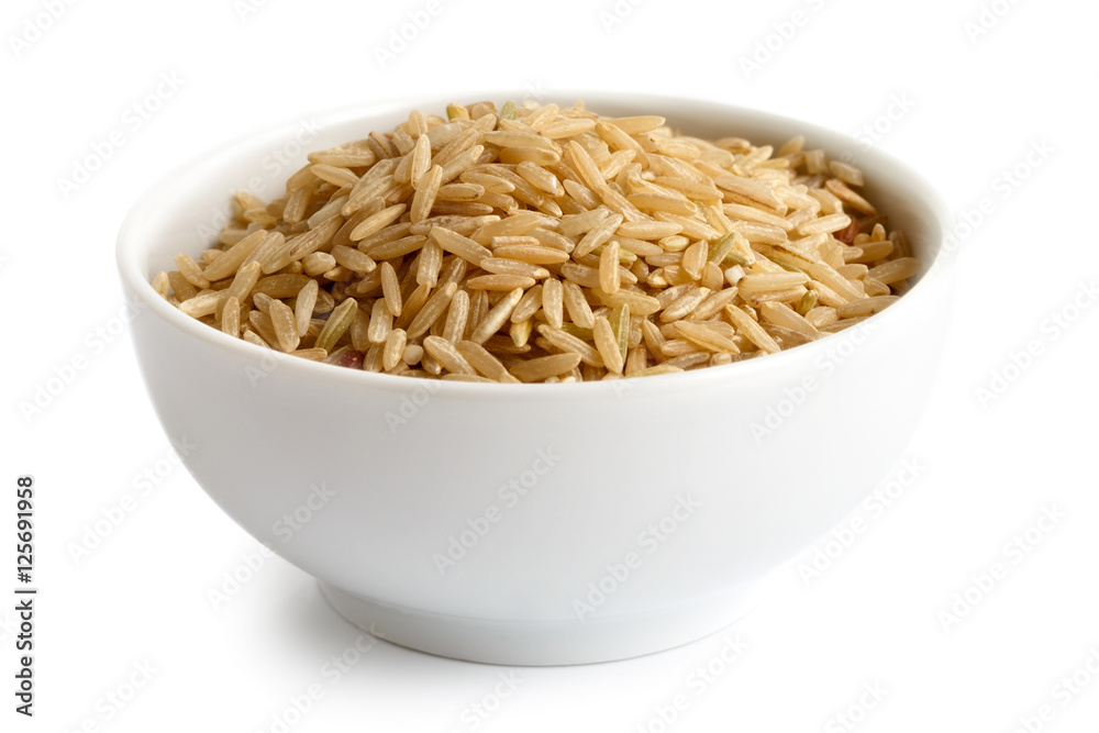 Bowl of long grain brown rice isolated on white.
