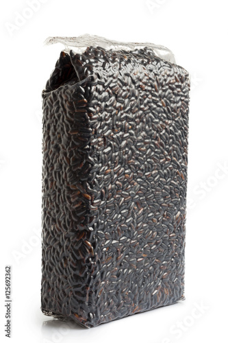 Vacuum packed Nerone black long grain rice isolated on white. photo