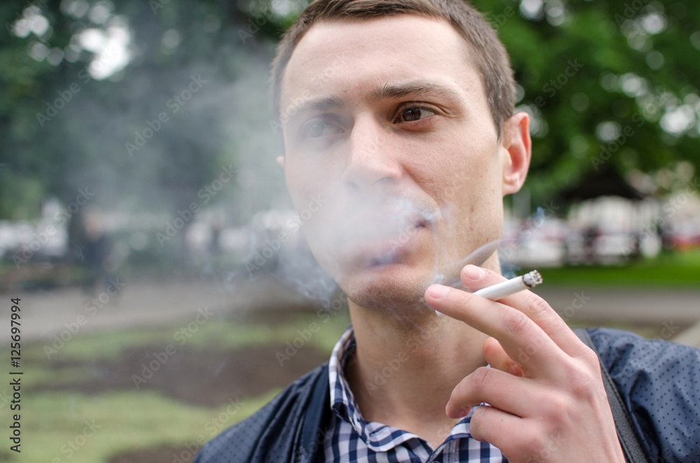 Young man smoking cigarette 