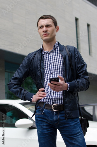 Tableau sur toile Young man using his phone
