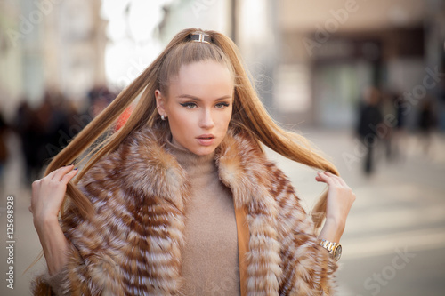Photography Beautiful young woman with long hair walking in the city