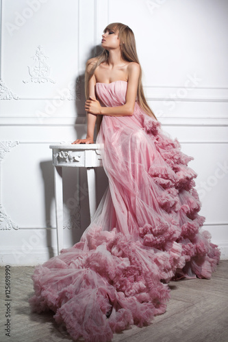 Portrait of a fashion woman in gorgeous long pink dress