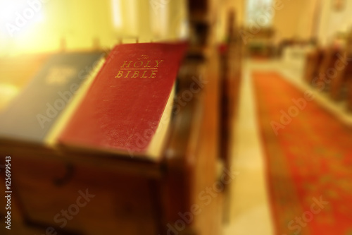 Abstract picture of holy bible with blurred church background