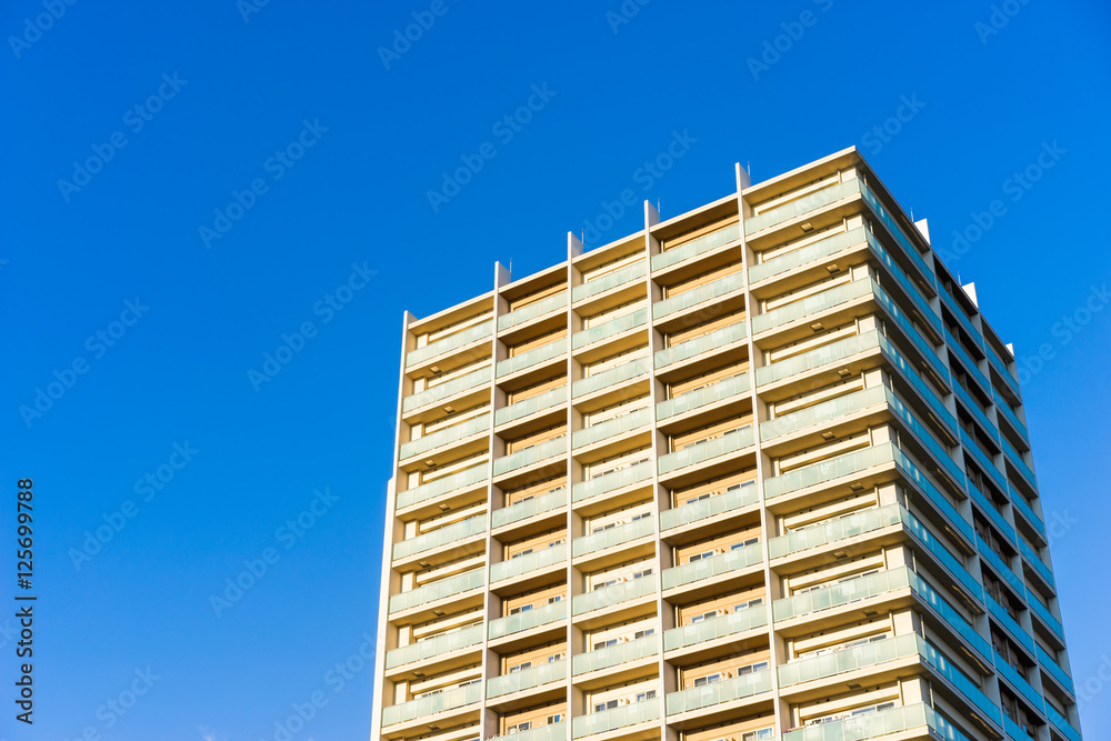 Real estate image, apartment building against blue sky