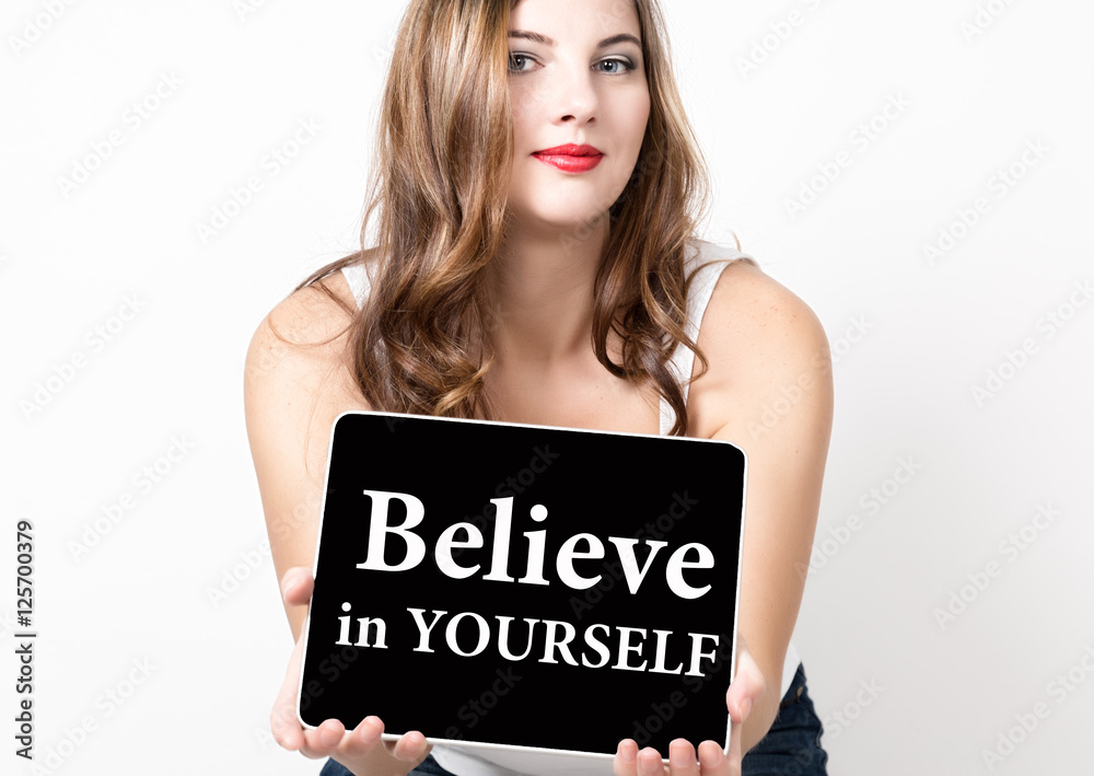 believe in yourself written on virtual screen. technology, internet and networking concept. beautiful woman with bare shoulders holding pc tablet believe in yourself written on virtual screen. technology, internet and networking concept. beautiful woman with bare shoulders holding pc tablet