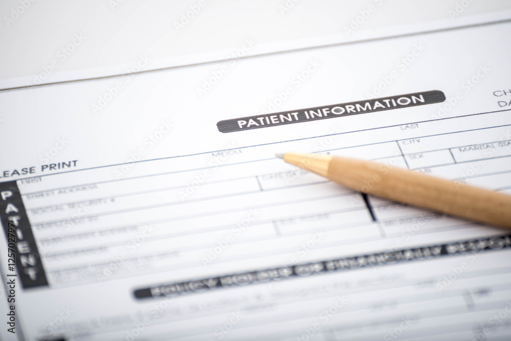 Patient information form and pen on desk,Medical questionnaire Patient information form and pen on desk,Medical questionnaire