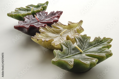 decorative candles in the form of a leaf on a light background 