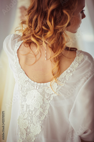 beautiful and gentle bride in a white nightgown