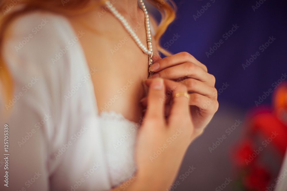 beautiful necklace with pearls on the gentle neck of the bride